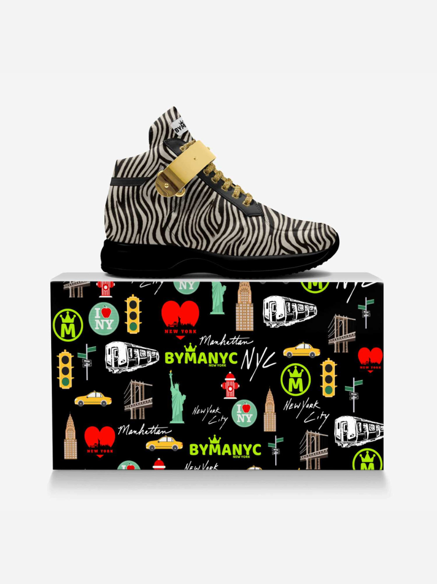 Zebra-patterned sneaker on a colorful shoe box with New York-themed illustrations.