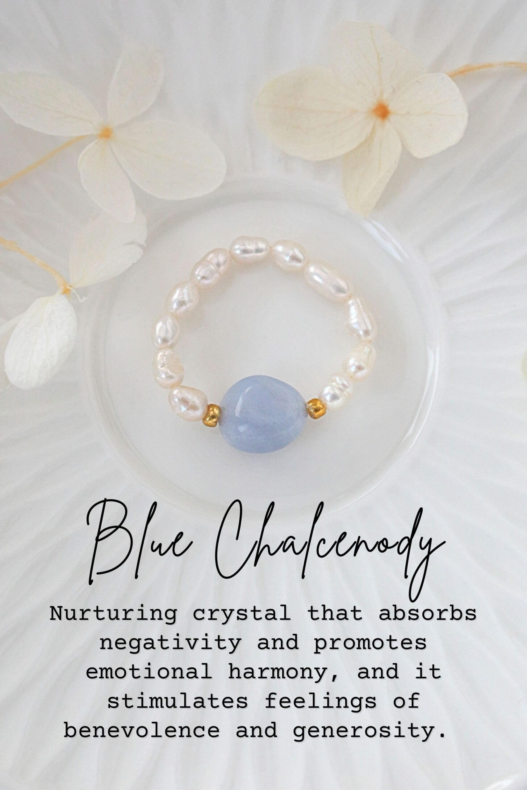 Pearl bracelet with a blue stone on a white plate with flowers, text about Blue Chalcedony crystal.