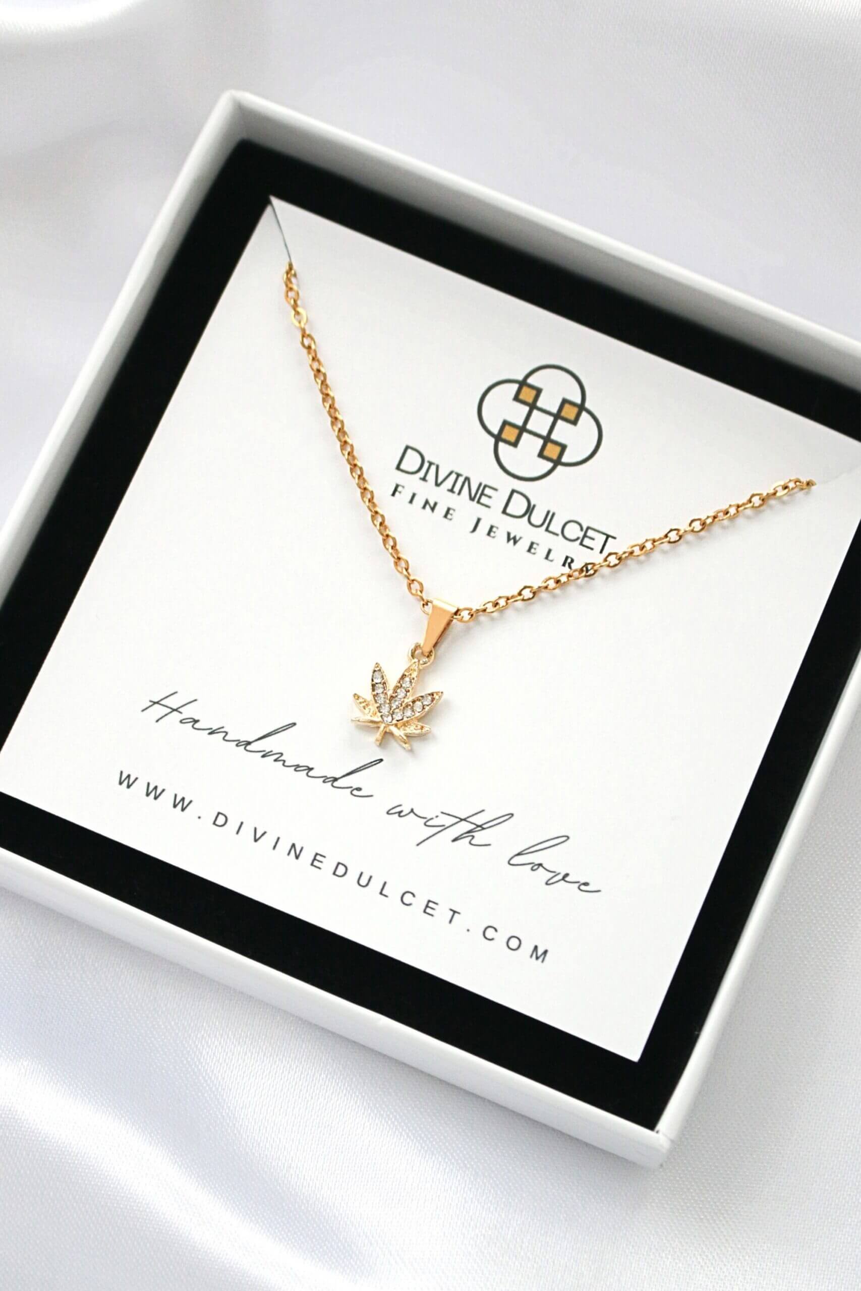Gold necklace with a leaf pendant on a Divine Dulcet card in a box