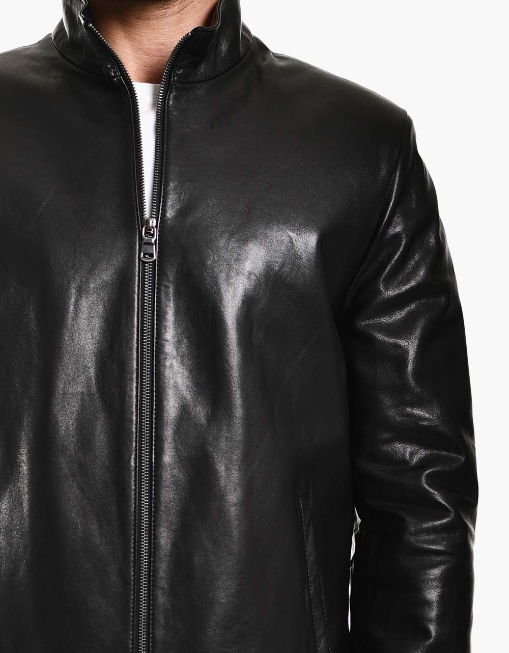 Black leather jacket worn by a person on a white background