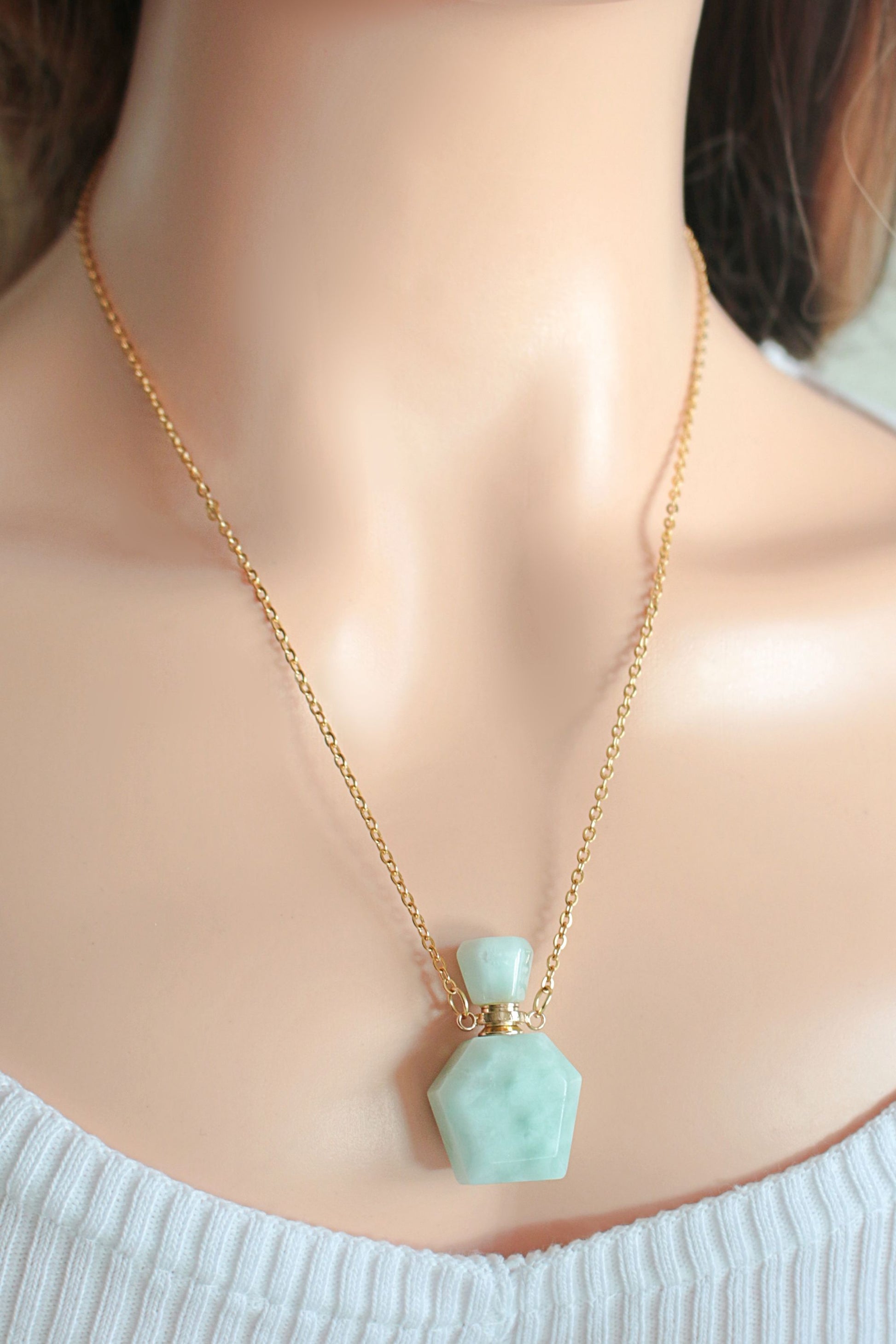 Necklace with a light blue pendant on a mannequin