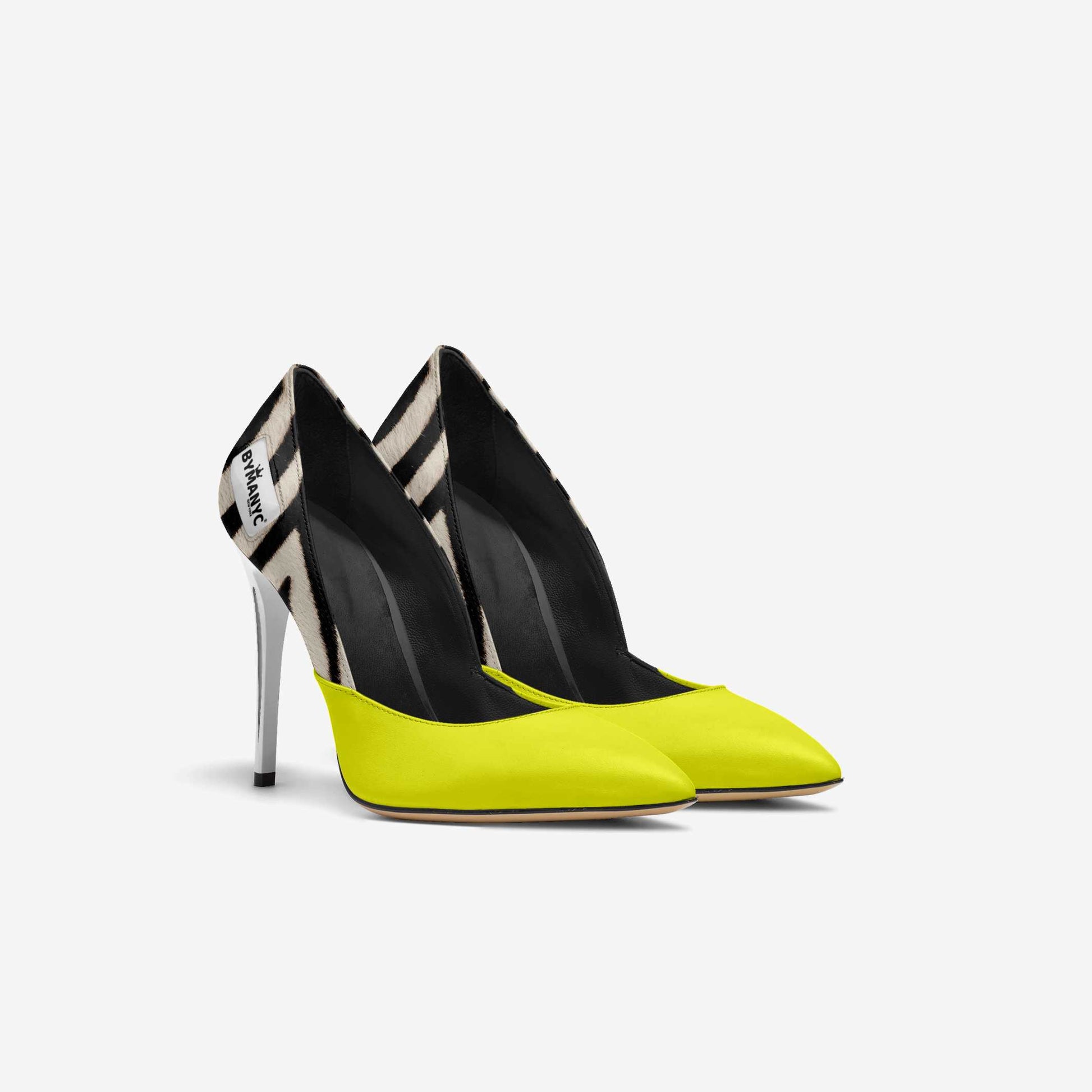 Pair of high-heeled shoes with black and yellow design on a white background