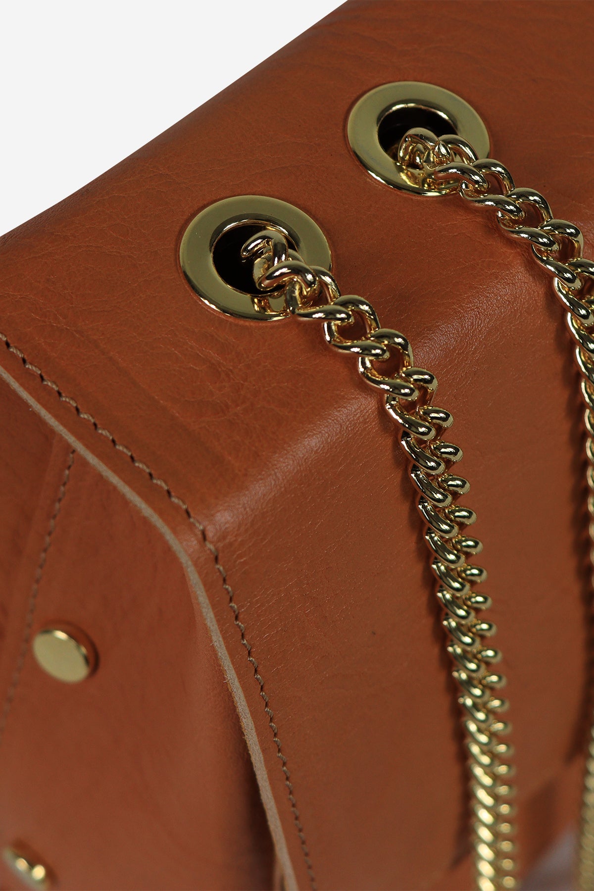 Close-up of a brown leather handbag with gold chain strap and hardware.