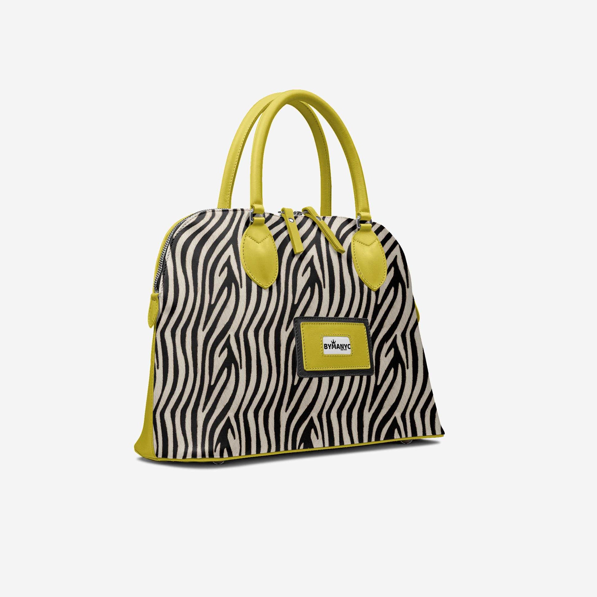 Zebra print handbag with yellow accents on a white background