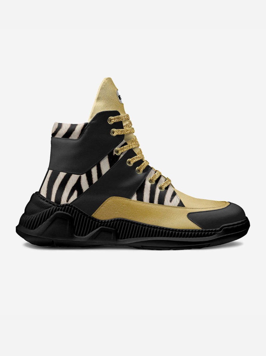 Black, gold, and zebra-striped sneaker on a white background
