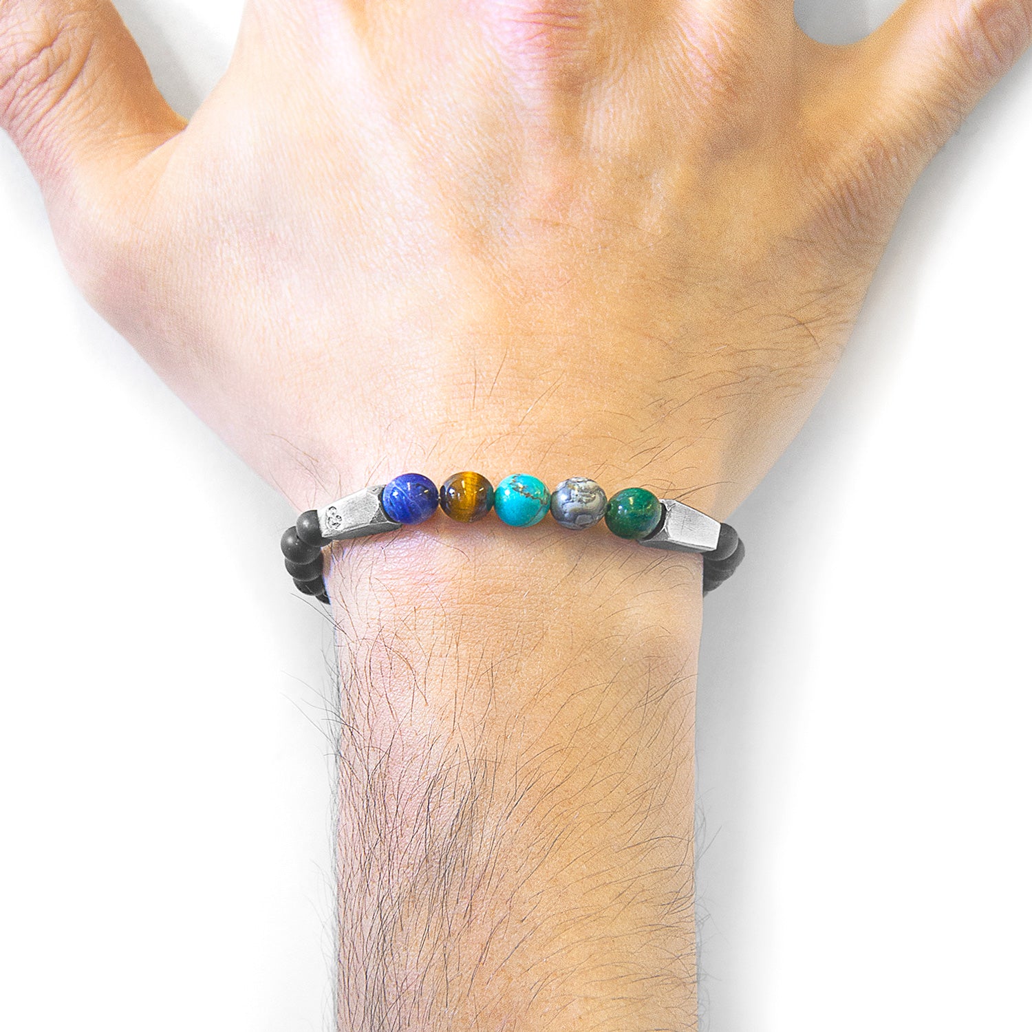 Bracelet with colorful beads on a wrist against a white background