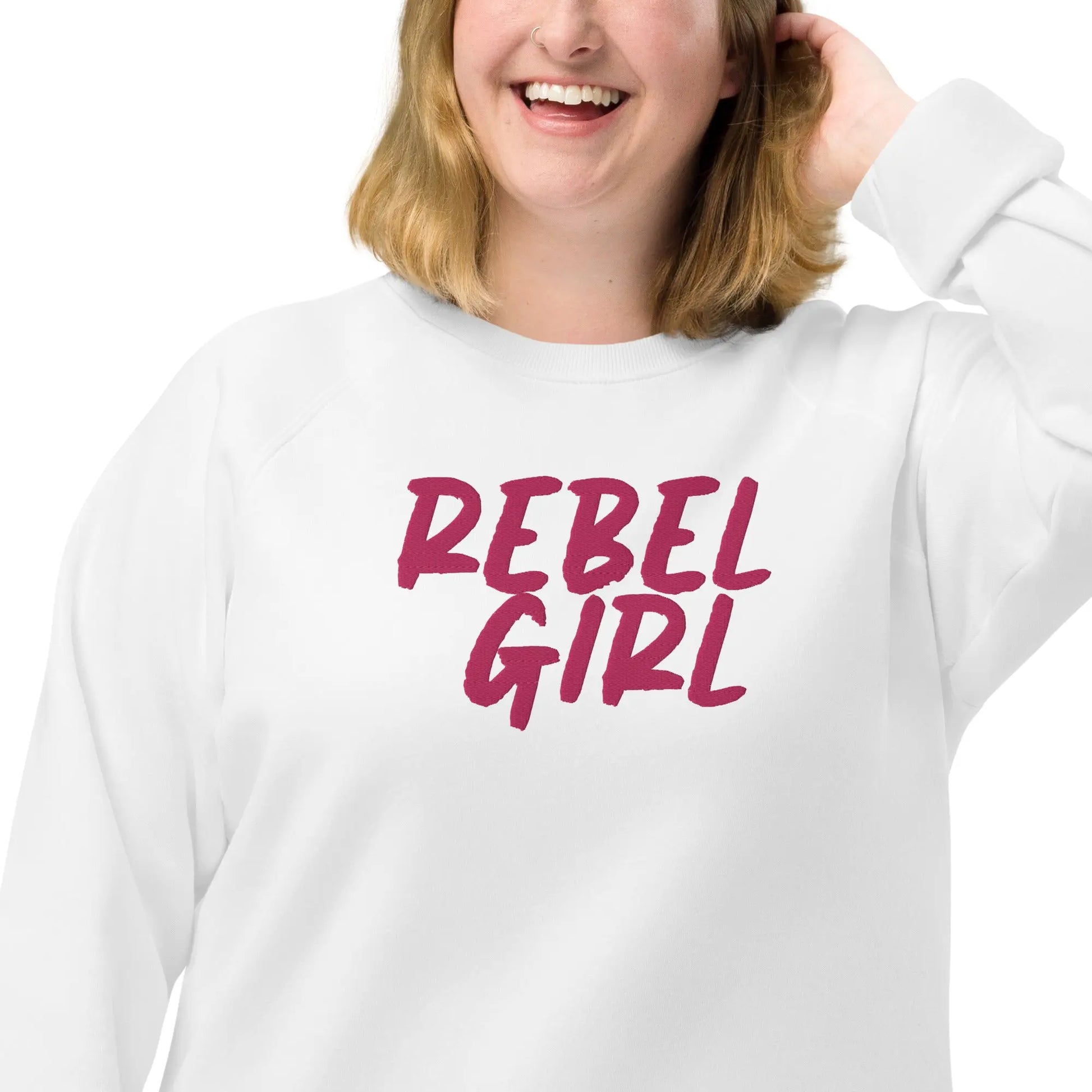 Person wearing a white sweatshirt with 'REBEL GIRL' text in pink on a white background
