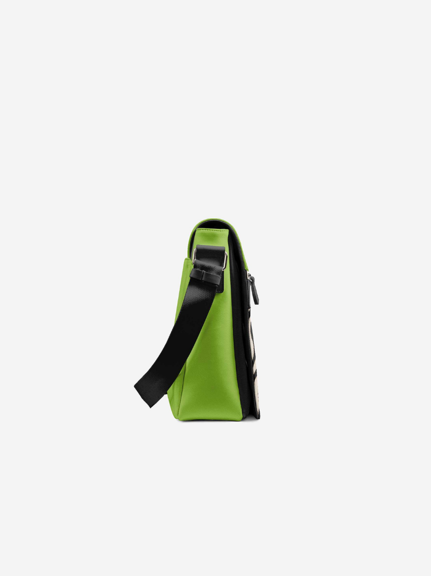 Green crossbody bag with a black strap on a white background