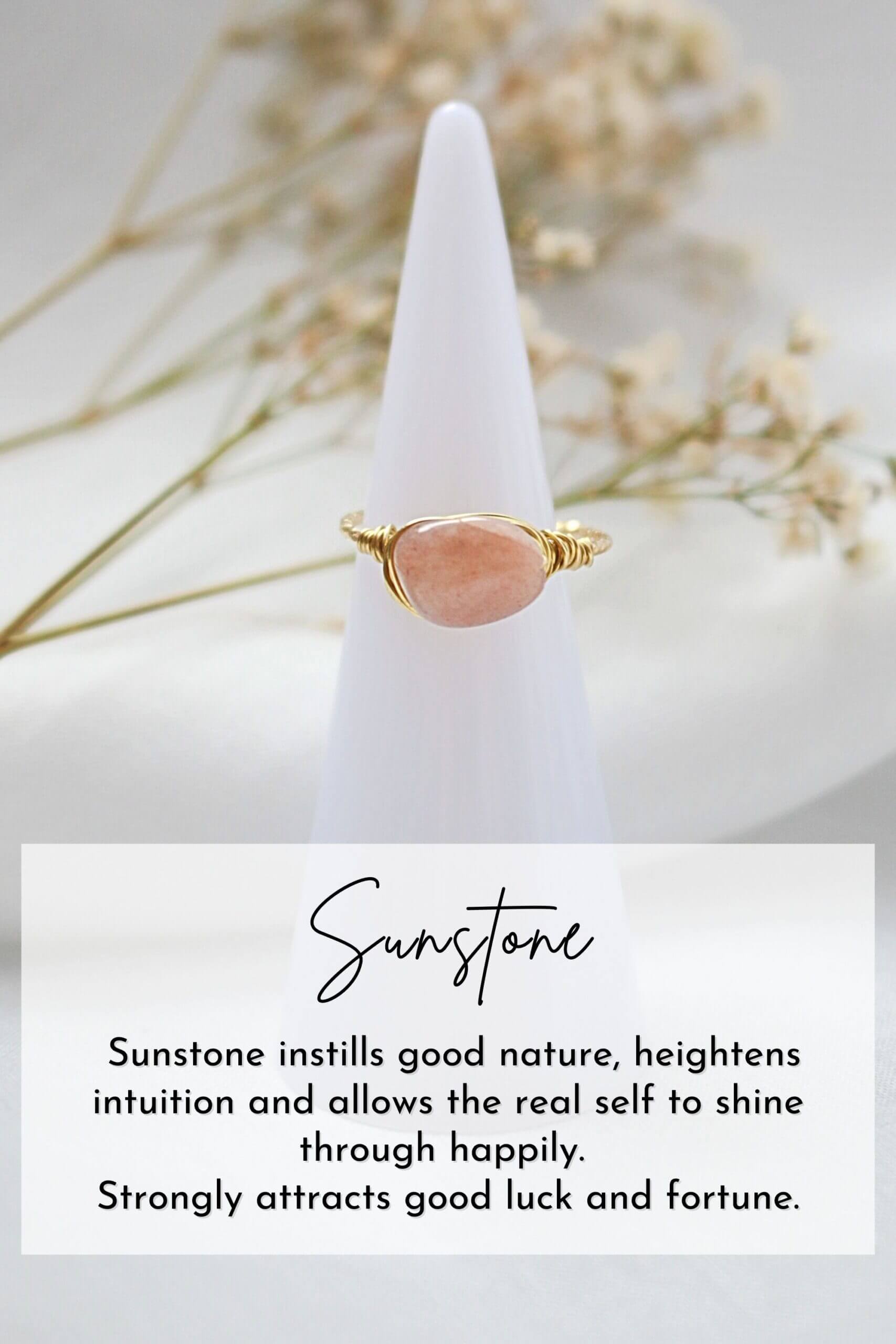 Sunstone ring on a white cone with dried flowers in the background