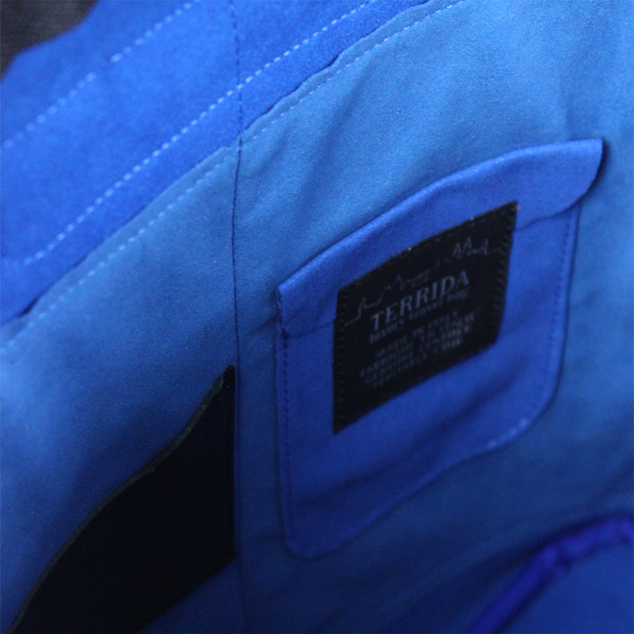 Close-up of a blue fabric with a Terrida label.