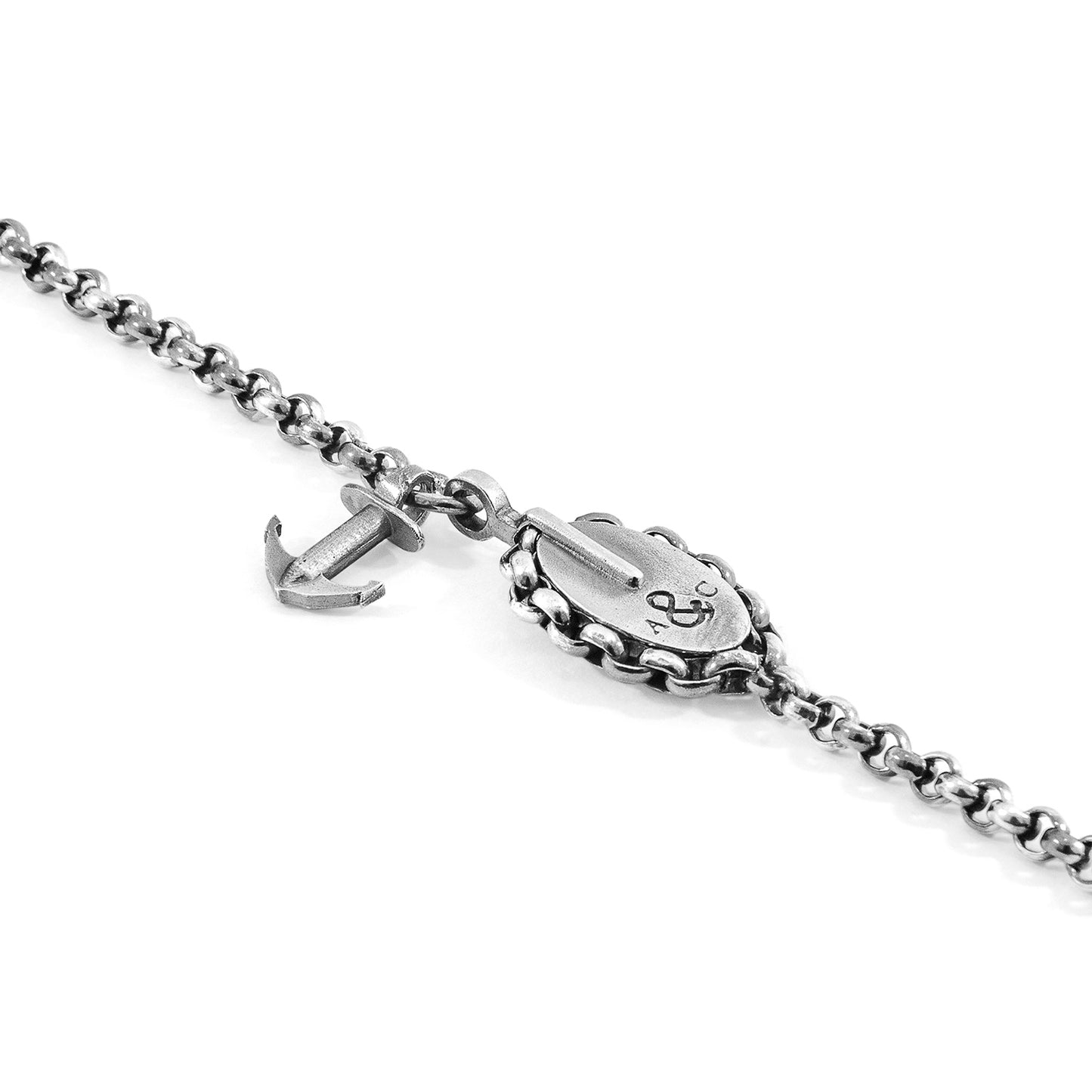 Silver chain bracelet with anchor charm on a white background