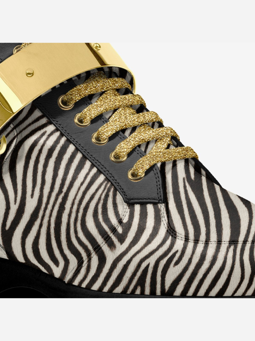 Zebra-patterned sneaker with gold accents on a white background