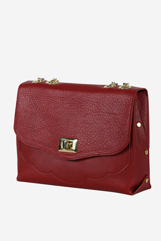 Red handbag with gold accents on a white background