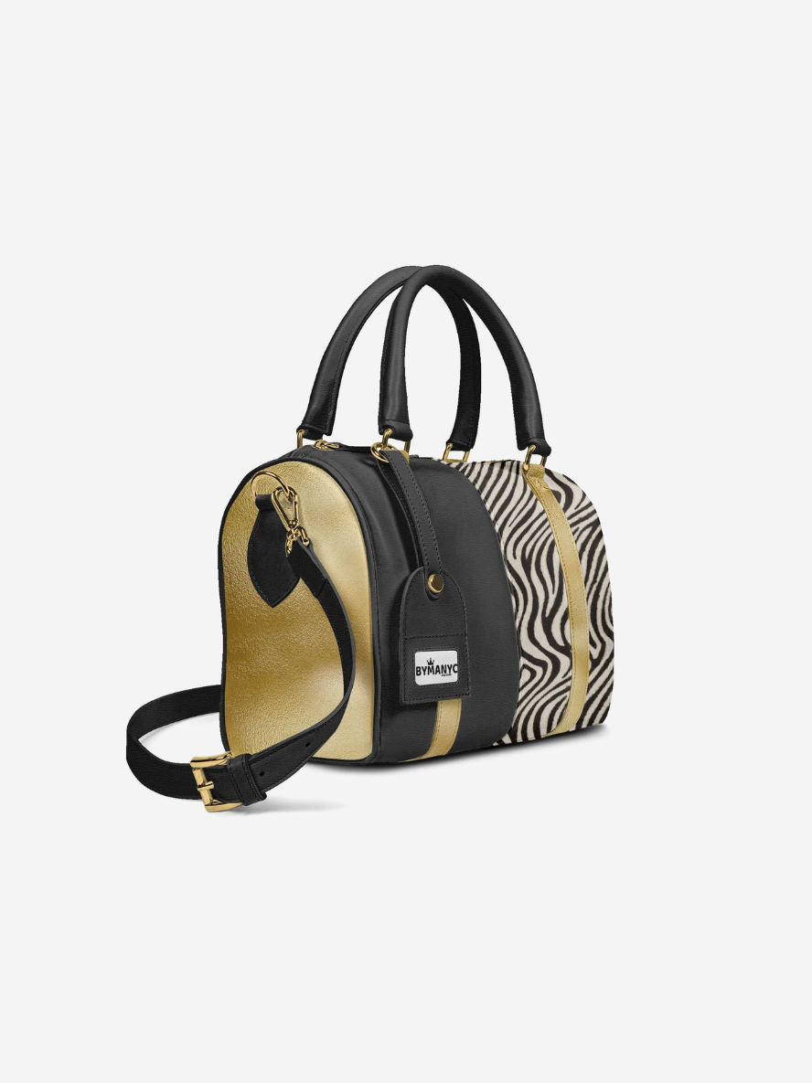 Handbag with zebra print and black accents on a white background