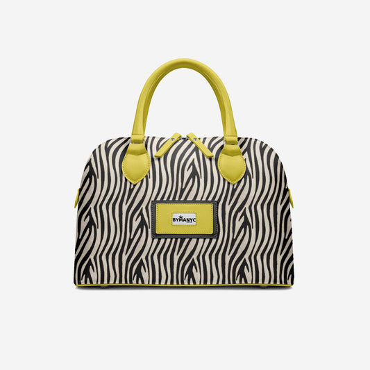Handbag with zebra pattern and yellow accents on a light gray background