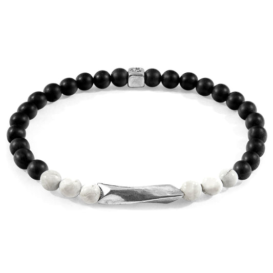 Black beaded bracelet with a silver tag on a white background