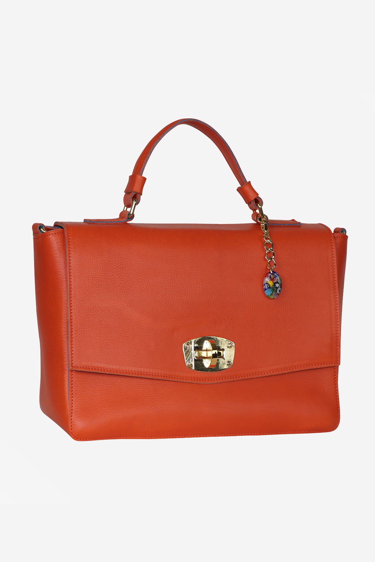 Orange handbag with a decorative clasp on a white background
