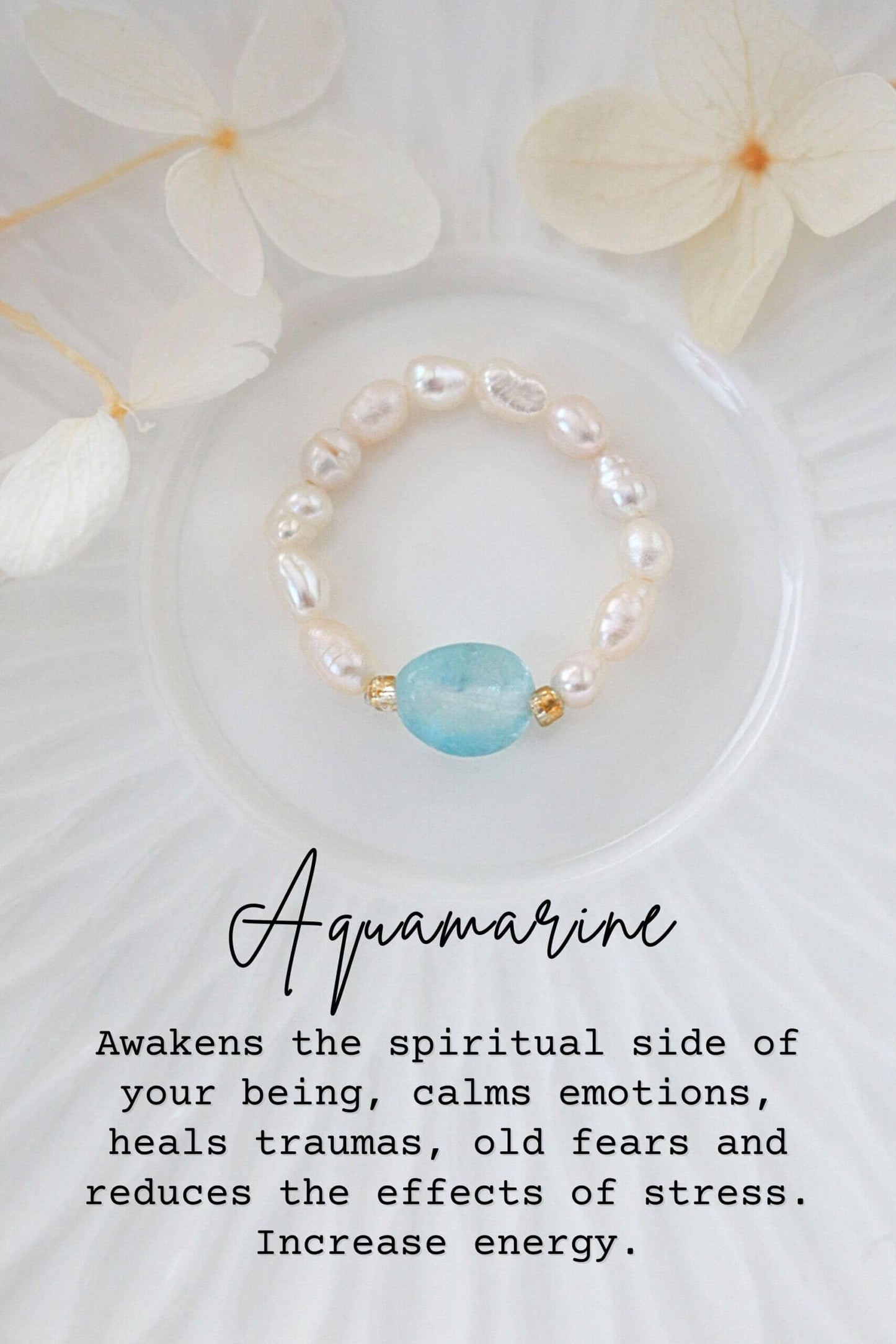 Pearl bracelet with a blue gemstone on a white background with flowers, text about aquamarine's properties.