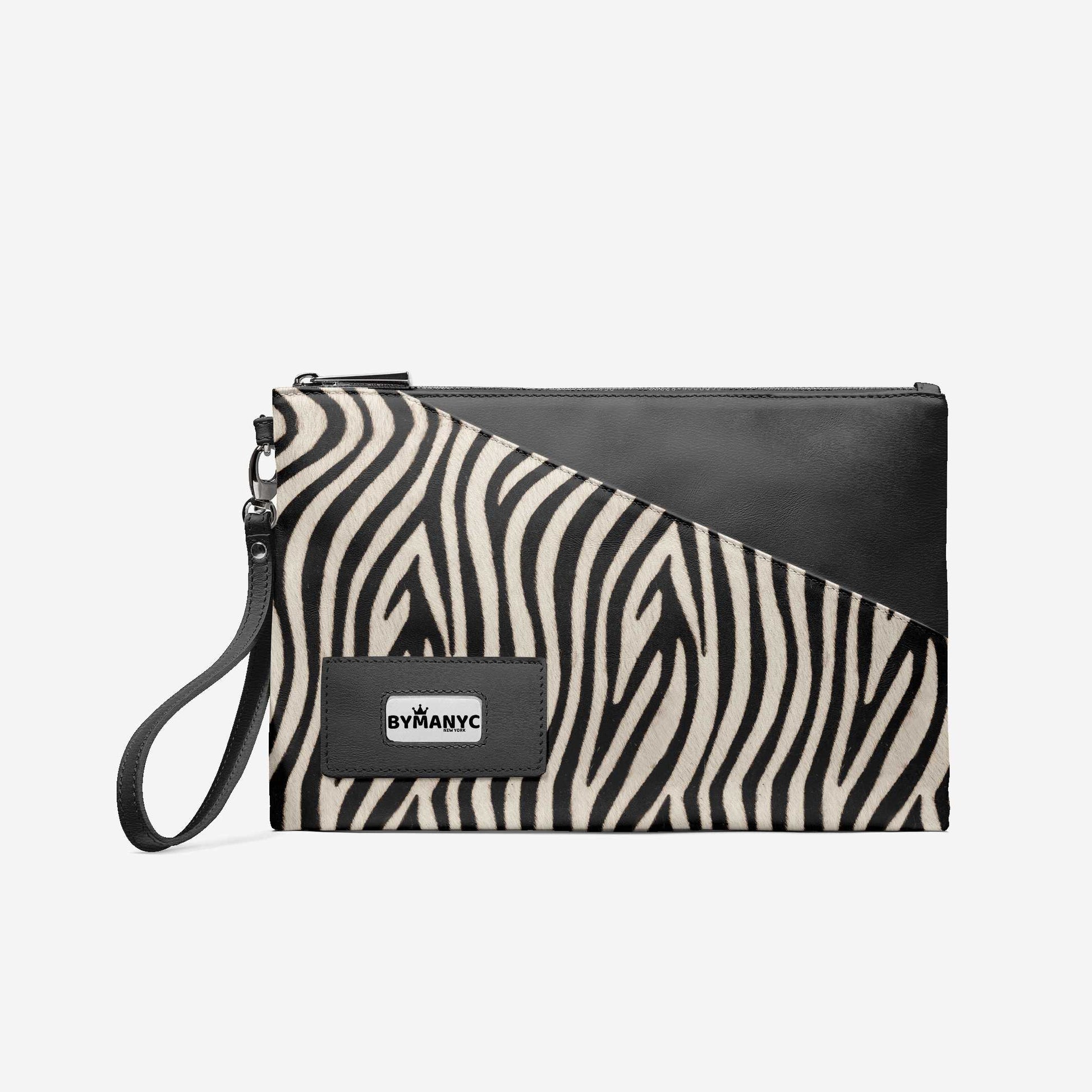 Zebra print clutch bag with black leather accents on a white background