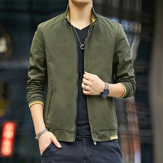 Person wearing a green jacket with a blurred background