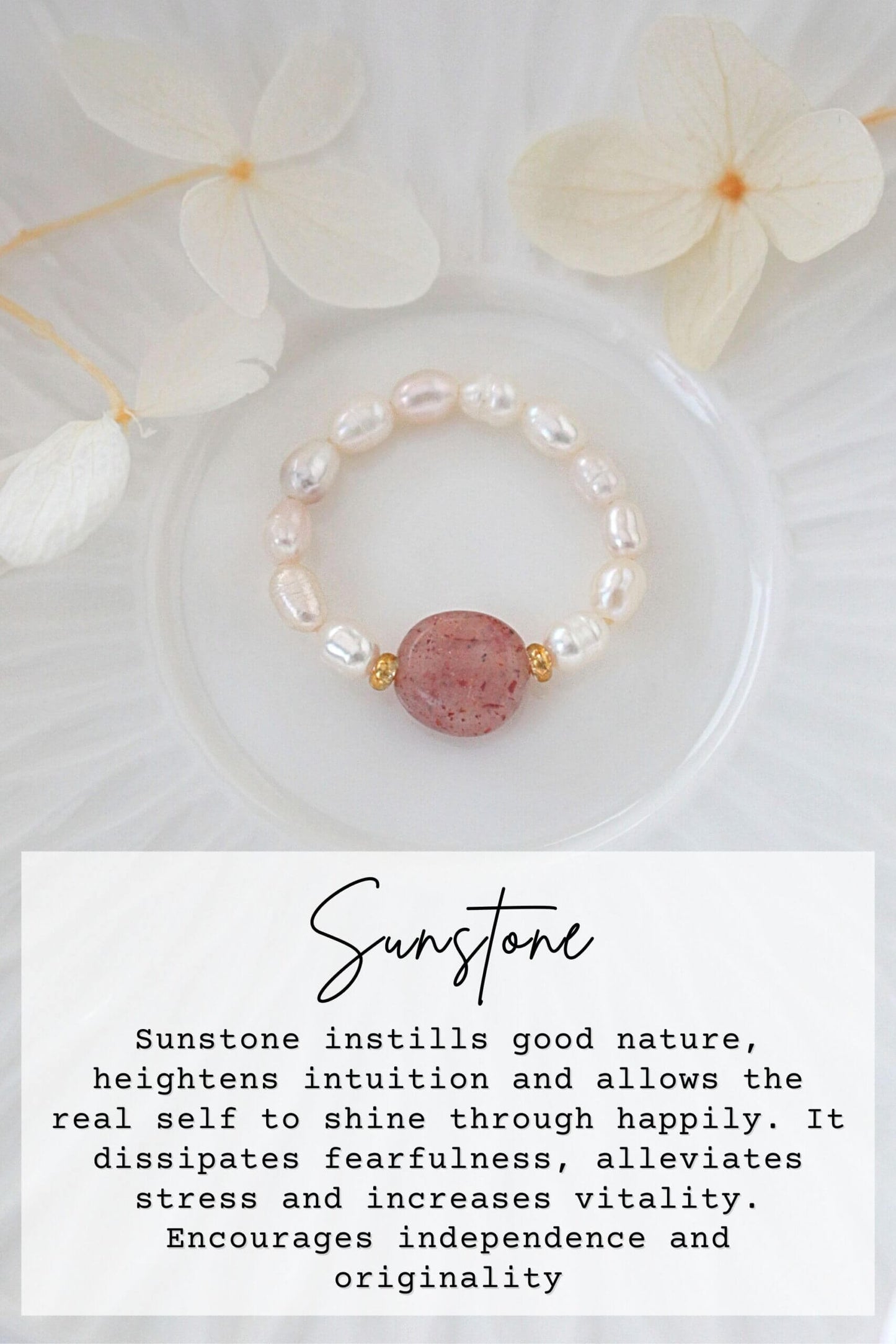 Pearl bracelet with sunstone bead on a white background with flowers