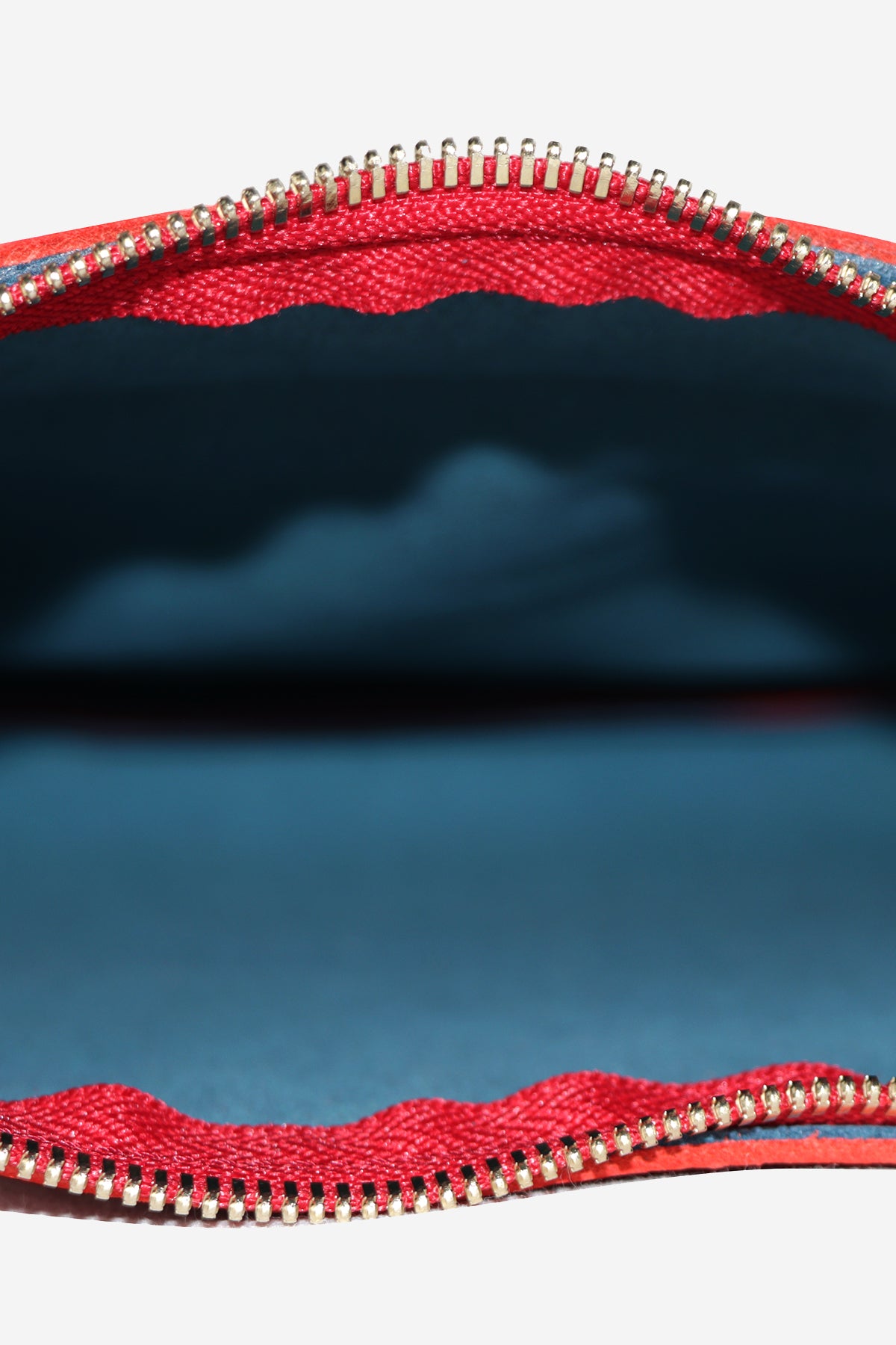 Close-up of a red zipper on a white background