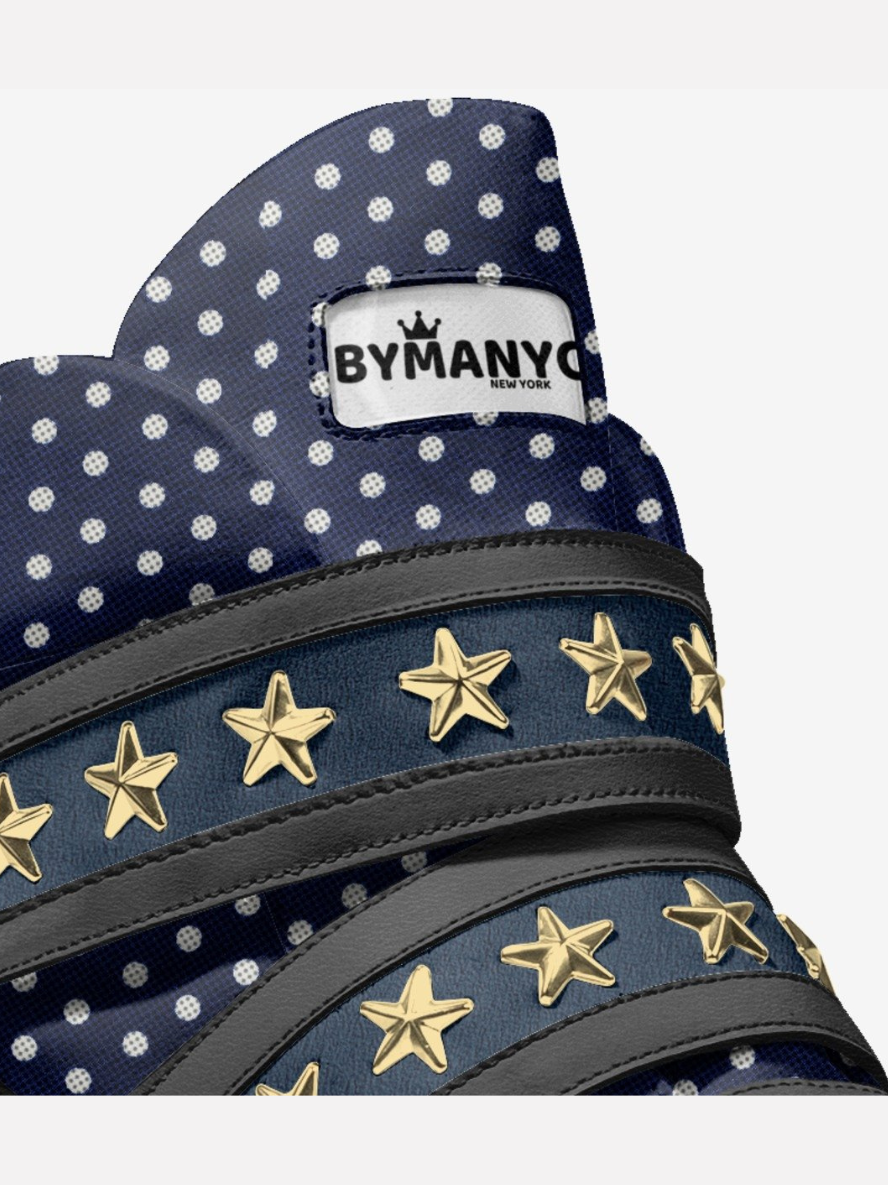 Navy blue bag with white polka dots and gold star embellishments, featuring 'Bymany' brand.