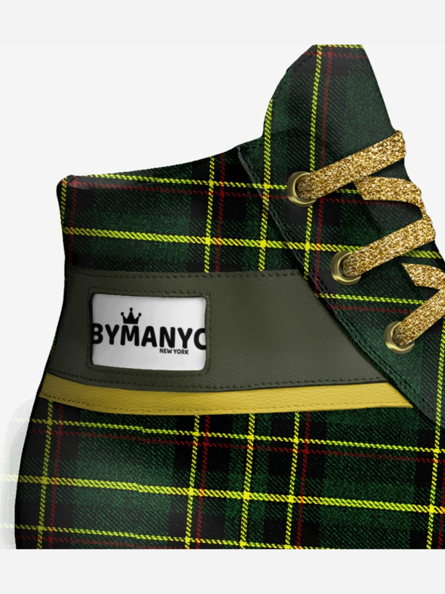 Green plaid shoe with gold accents and By Manyo New York label on a white background
