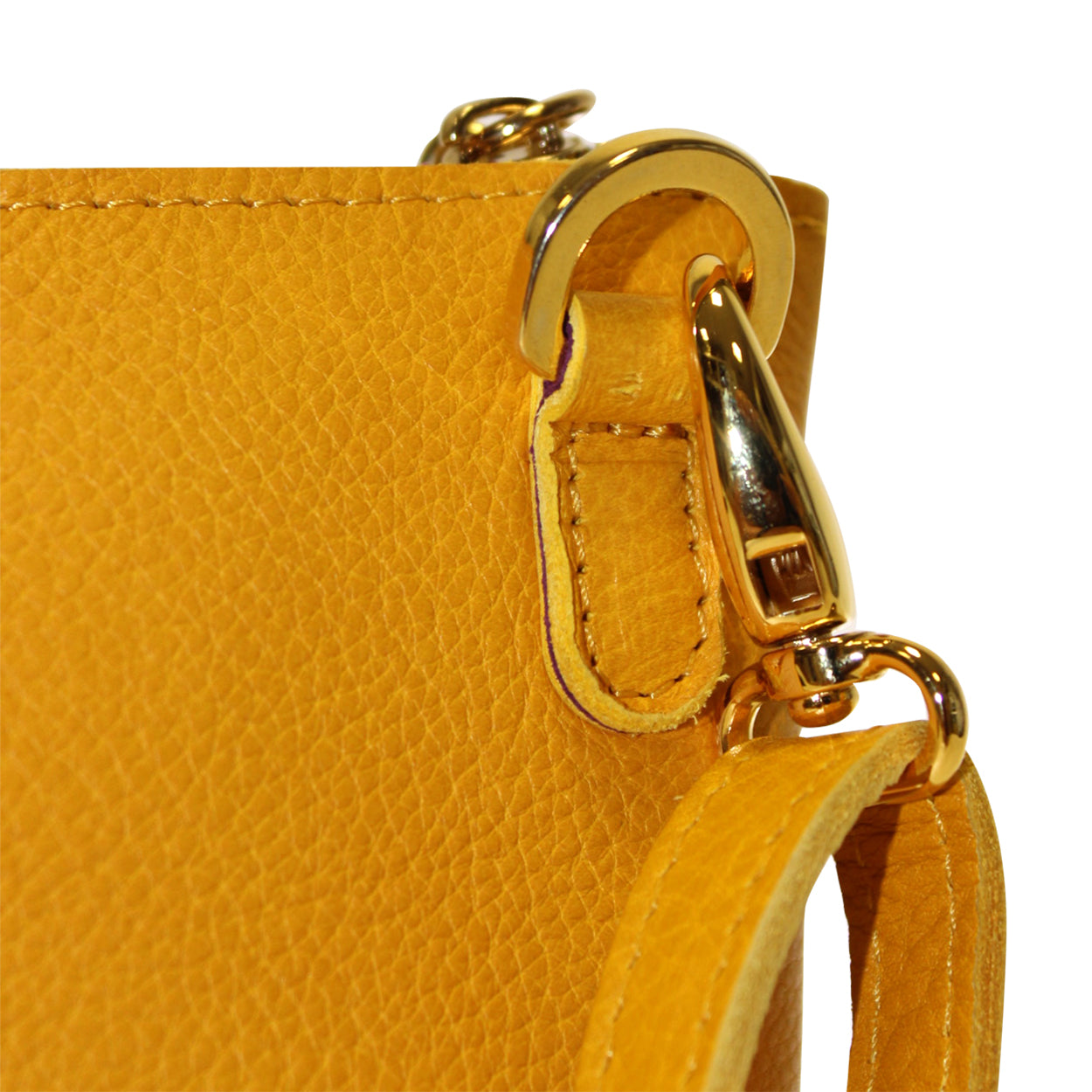 Close-up of a yellow handbag with a gold clasp on a white background