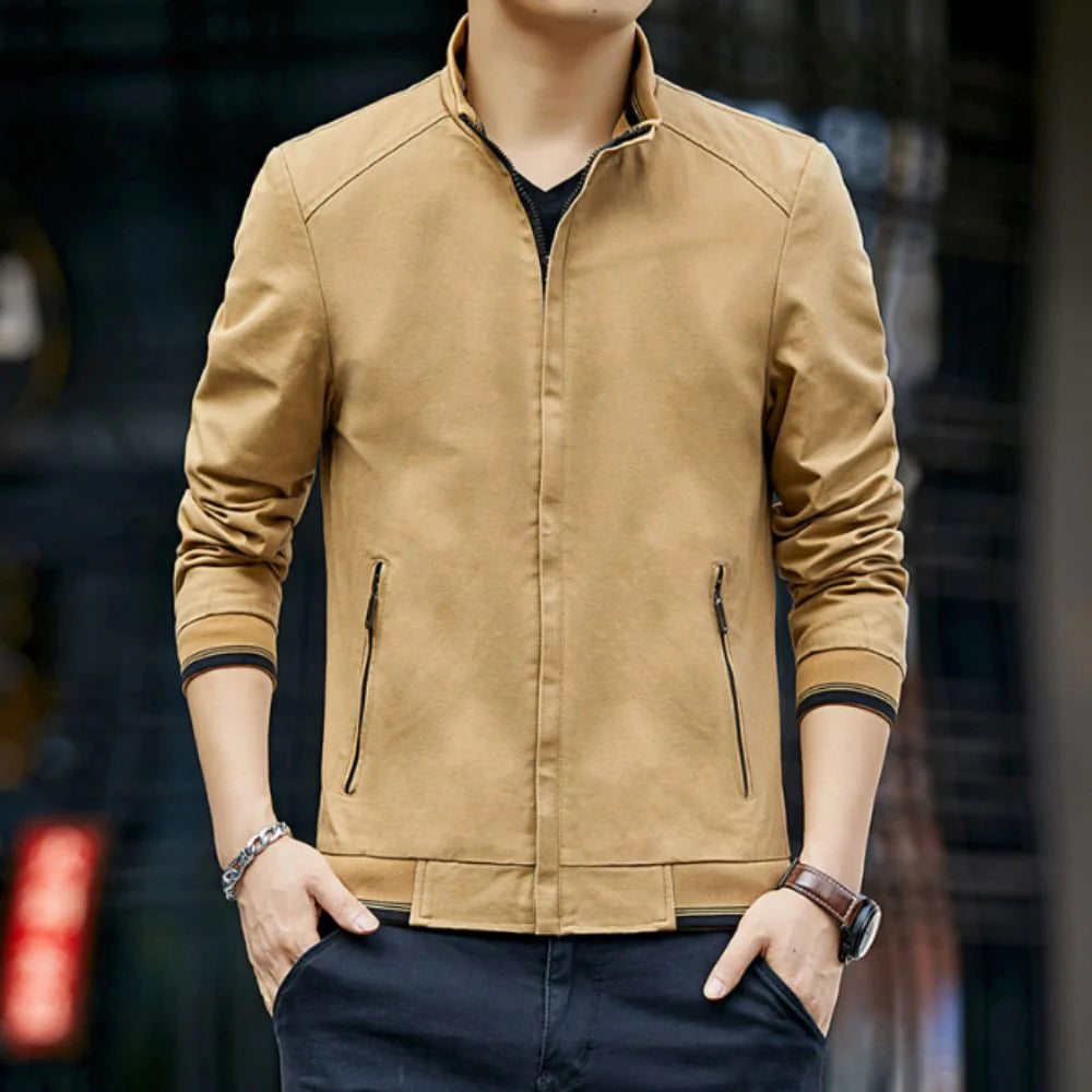 Man wearing a tan jacket with a blurred background