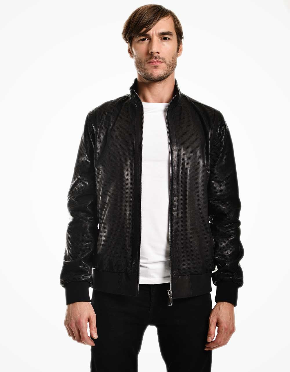 Man wearing a black leather jacket over a white shirt on a white background