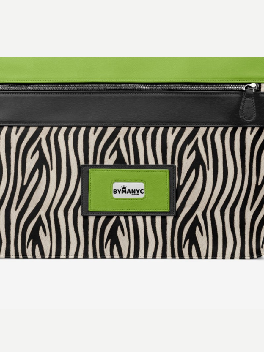 Zebra patterned pouch with green zipper and By Many NYC logo on a white background