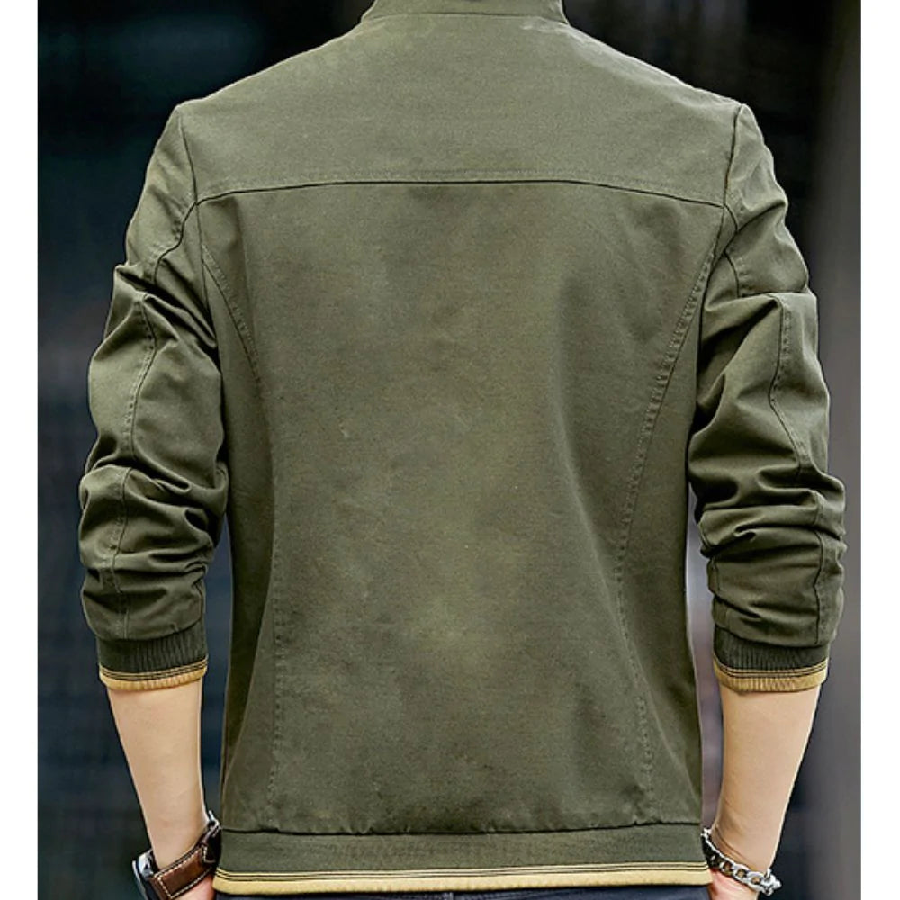 Green jacket worn by a person on a dark background