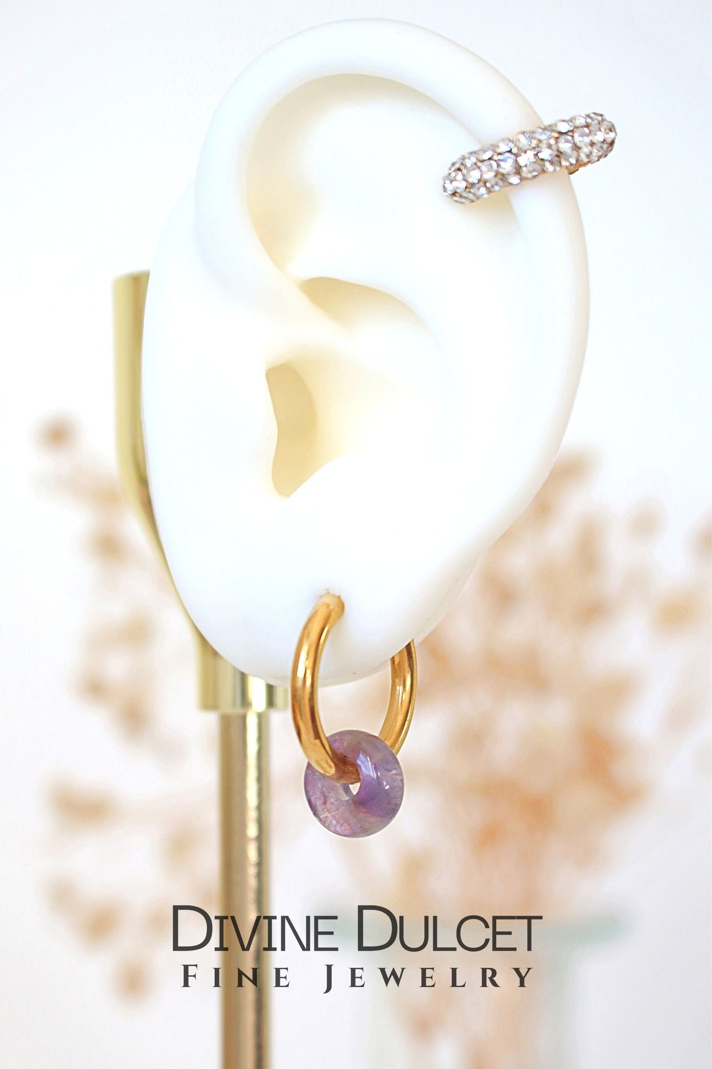 Earring displayed on a stand with 'Divine Dulcet Fine Jewelry' branding.