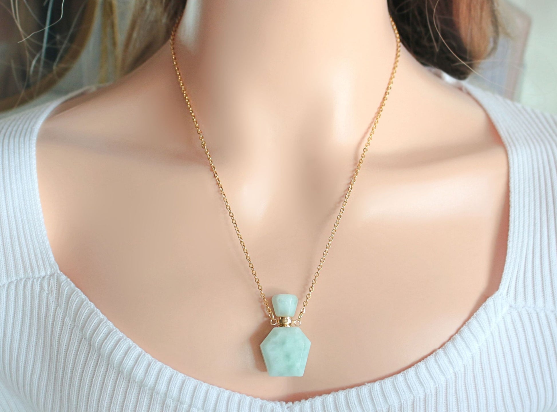 Necklace with a turquoise pendant on a mannequin