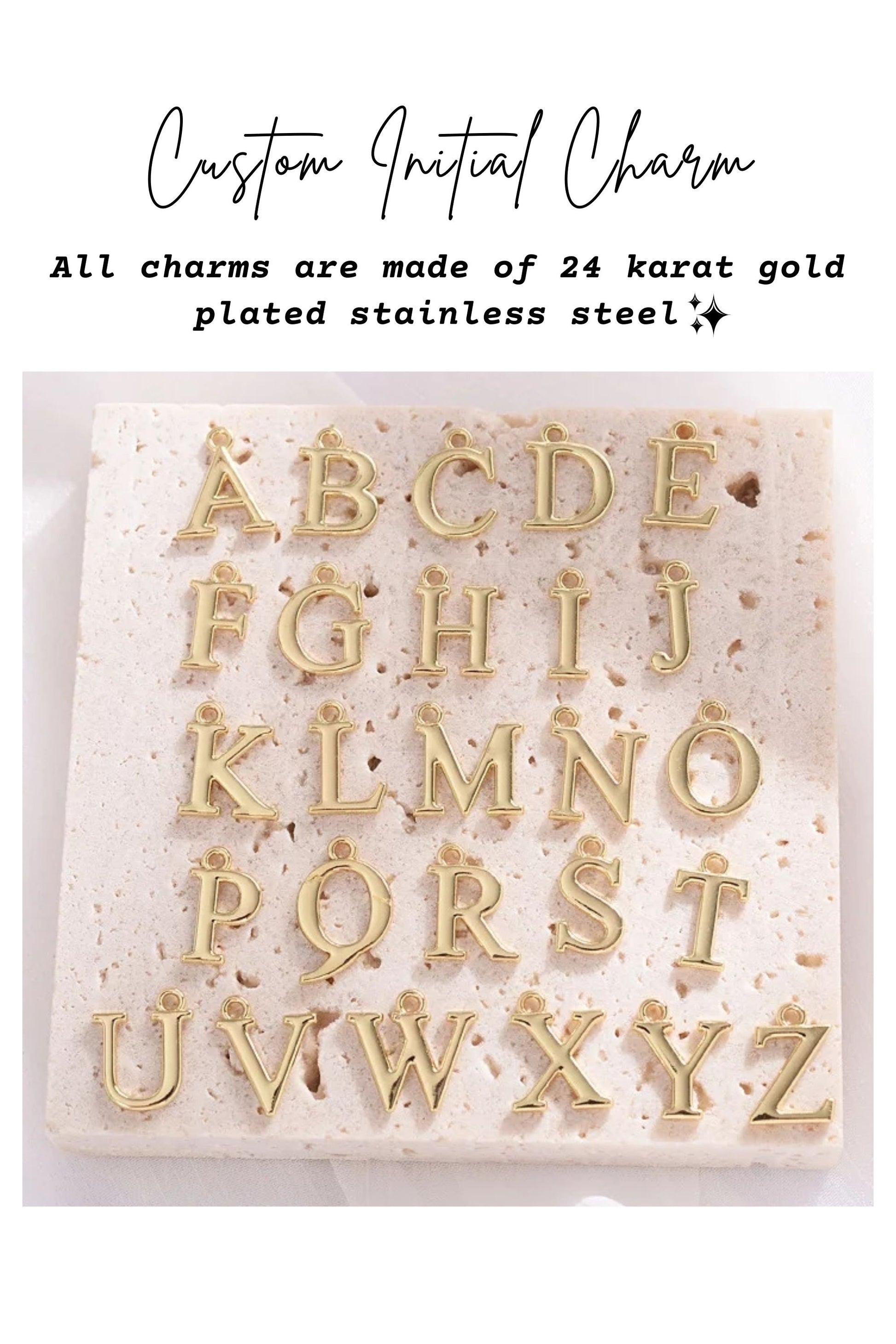 Gold letter charms on a white stone surface with text about material and customization.