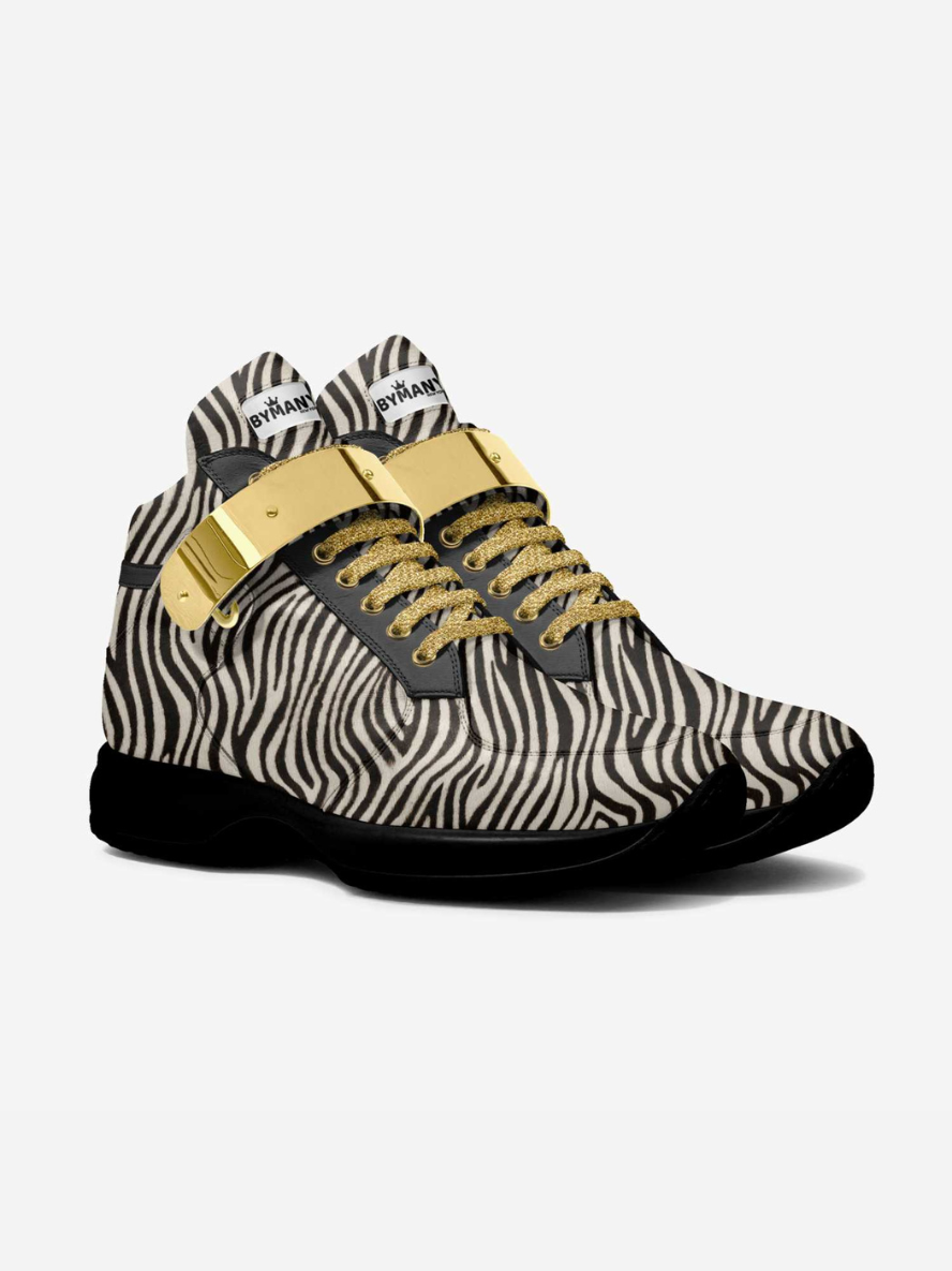 Zebra-patterned sneaker with gold accents on a white background