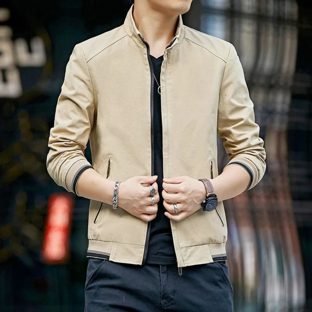 Man wearing a beige jacket with a blurred background