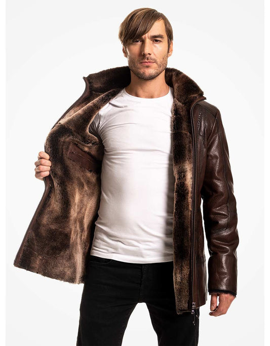 Man wearing a brown leather jacket with fur lining on a white background