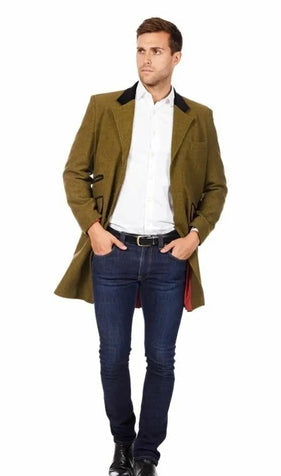 Man wearing a green coat, white shirt, and blue jeans on a white background