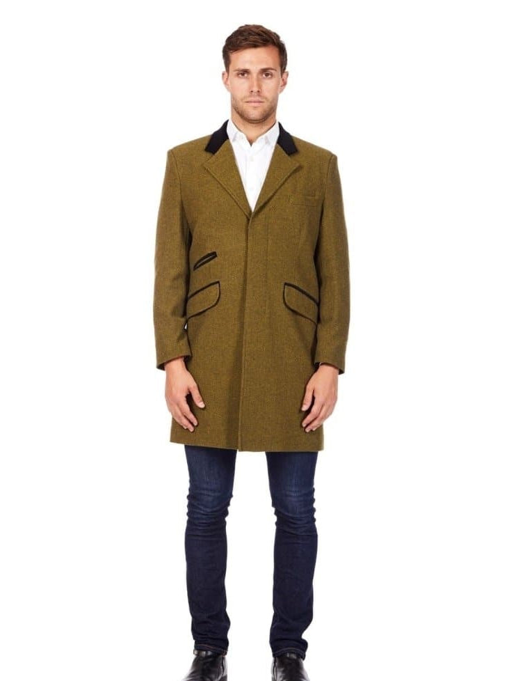 Man wearing a green coat with black accents on a white background