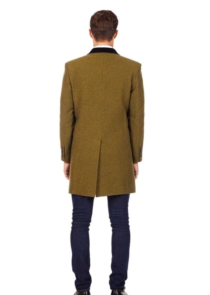 Man wearing a green overcoat from behind on a white background