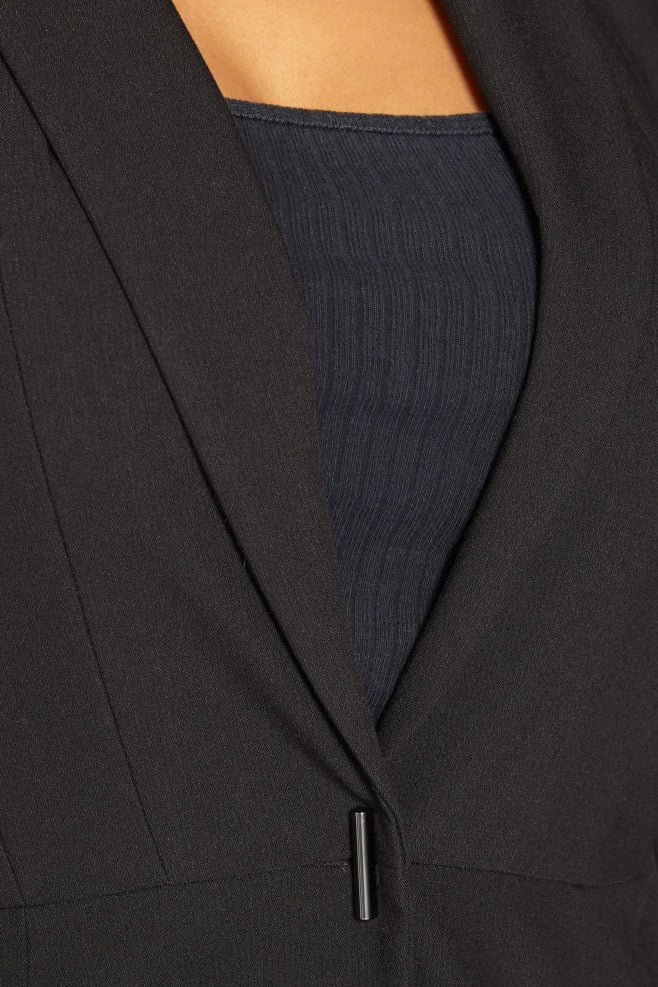 Close-up of a black garment with a textured blue lining