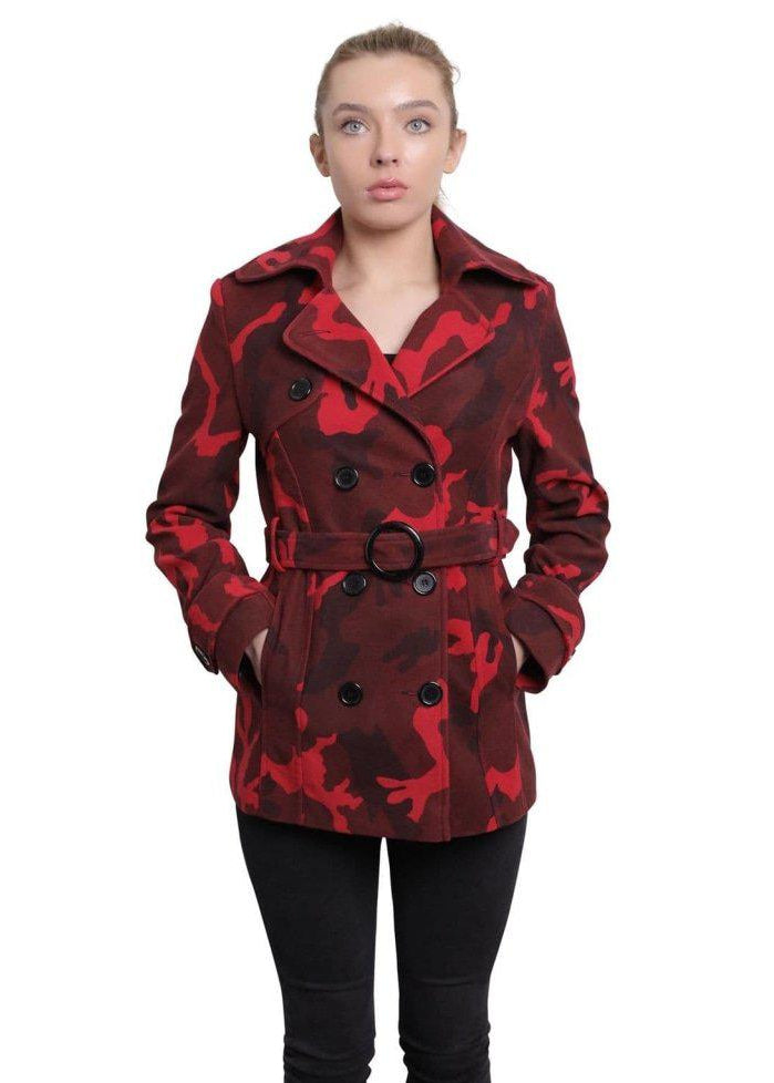 Woman wearing a red and black camouflage coat on a white background