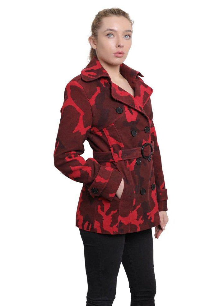 Woman wearing a red and black patterned coat on a white background