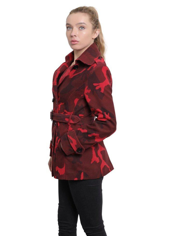Woman wearing a red and black patterned coat on a white background