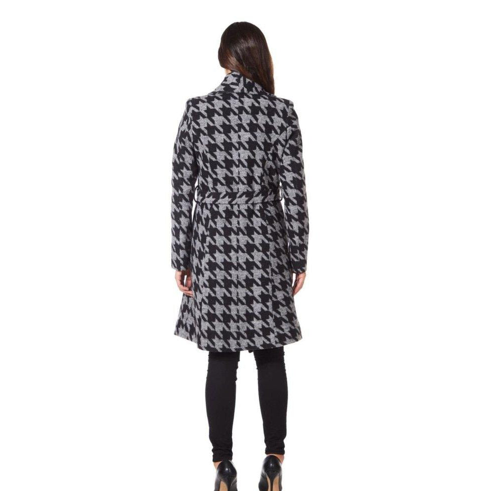 Woman wearing a black and white checkered coat on a white background