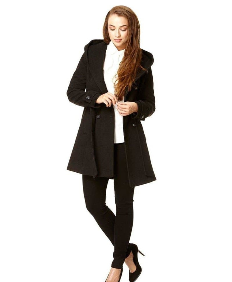 Woman wearing a black coat on a white background.