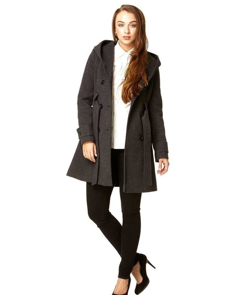 Woman wearing a gray coat with a white shirt and black pants on a white background.