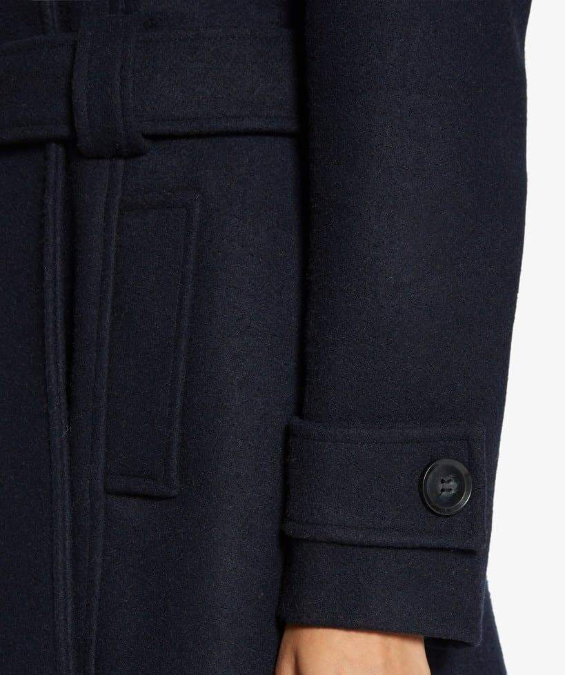 Navy blue coat with button detail on a white background